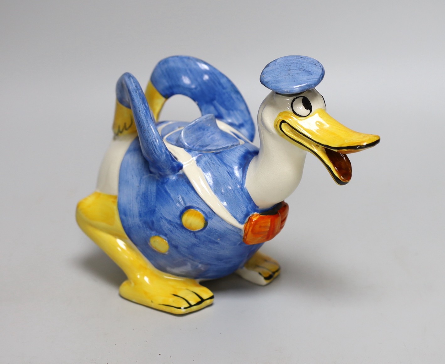 A Wade Heath Donald Duck teapot and cover, 22cms wide x 16.5cms high